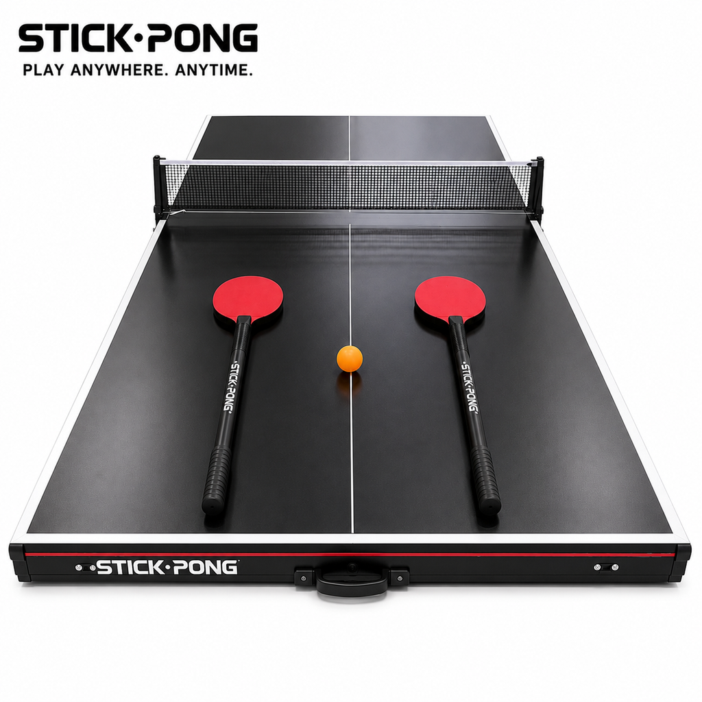 Stick Pong board in play mode with net, two red long-shaft paddles, and an orange ball