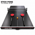 Stick Pong board in play mode with net, two red long-shaft paddles, and an orange ball